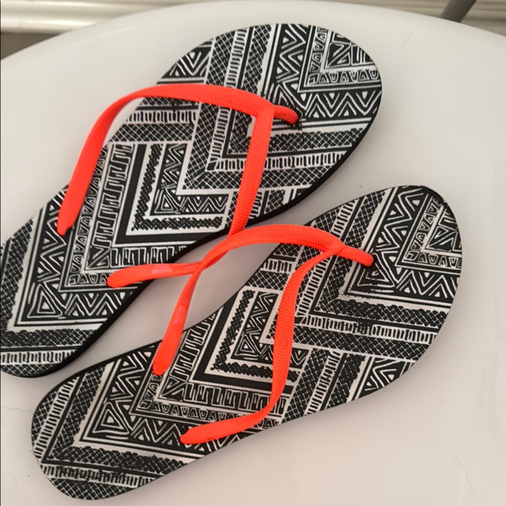 Black and White Geometric Flip Flops with Orange Straps